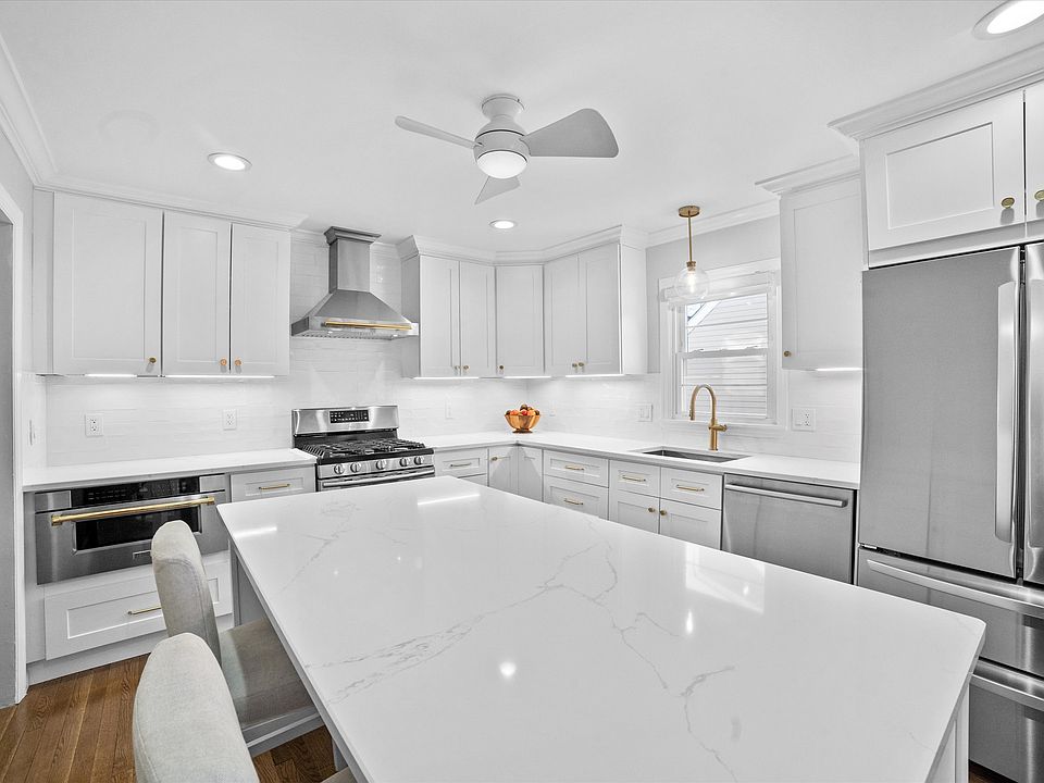 Renovated kitchen with custom cabinetry, stainless steel appliances, new refrigerator and dishwasher