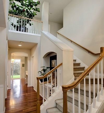 Elegant 2 story entrance with cherry wood floors and skylight. Opens to formal living room and dining room.