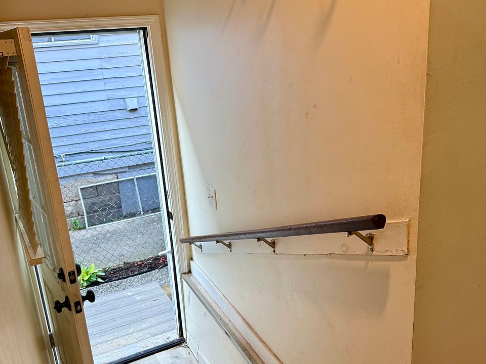 The side entry leads into a short hallway and the kitchen.