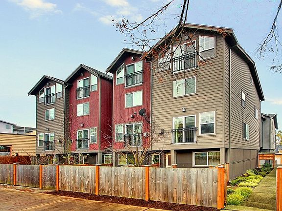 Large end unit with four floors of living space, one car attached garage in back, courtyard in front, and side gardens.