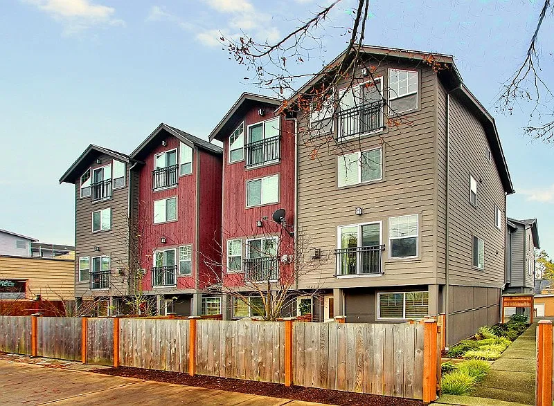 Large end unit with four floors of living space, one car attached garage in back, courtyard in front, and side gardens.