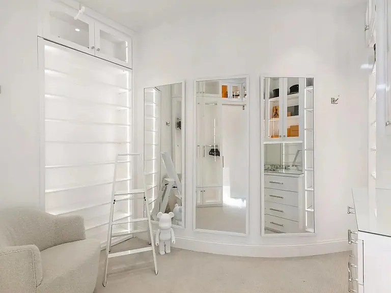 Modern walk-in closet with a flare of artwork