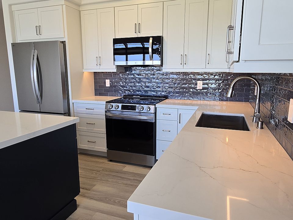 Open Concept Kitchen w/ Custom Cabinetry, Quartz Counter Tops and maximized Storage.