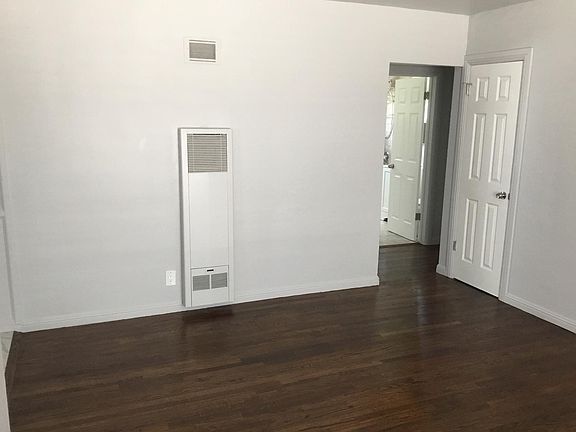 Part of living room into hallway, bath and bedroom