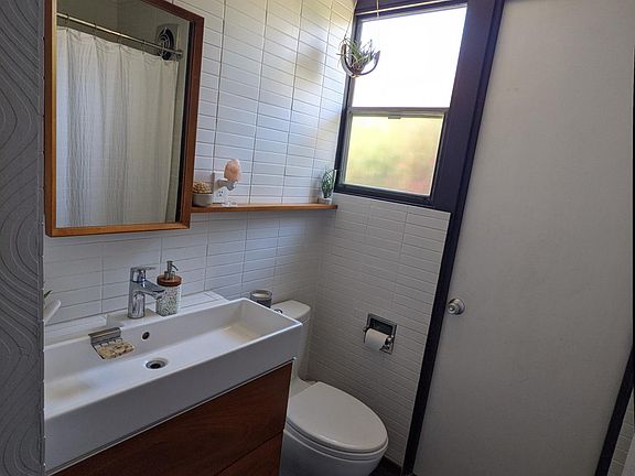 Guest bathroom with door leading to north side yard