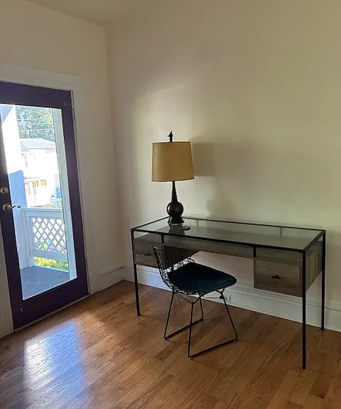 Door that leads to the beautiful front covered porch furnished with patio furniture.