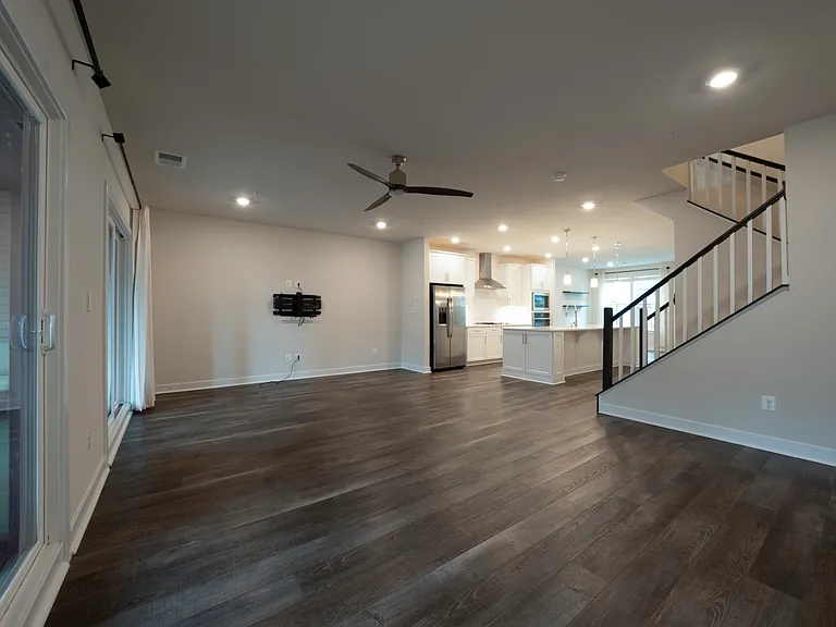 Living room comes with high end Sanus full motion TV mount with in-wall HDMI cable management and ethernet outlet. Overhead lighting and ceiling fan are smart/WiFi enabled. Two sliding doors to access large covered lanai balcony on either ends.