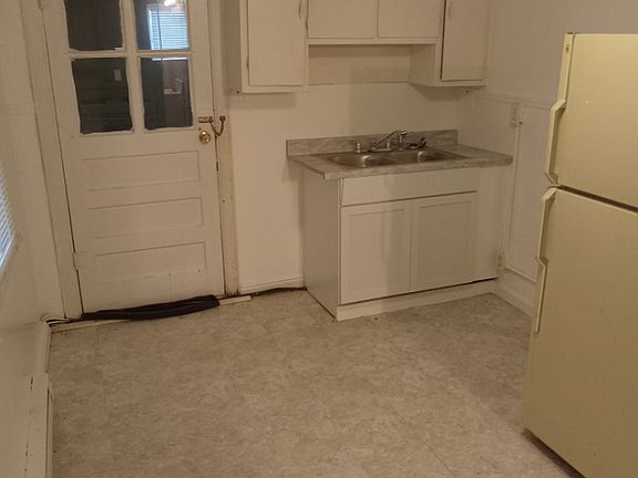 kitchen, door leads out to utility area