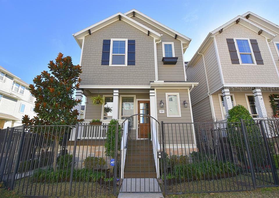 Beautiful traditional home with roomy front porch and great curb appeal. This home has its own private gate to the street and easy access to guest parking.