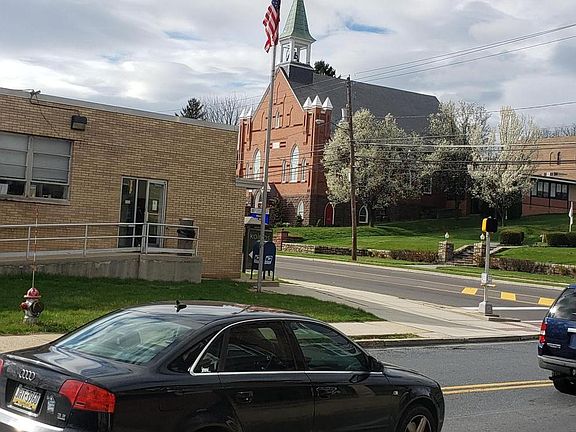 Church, bus stop and post office across the street