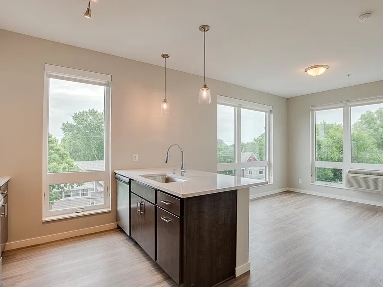 Large windows invite natural light, creating a bright and airy living space.