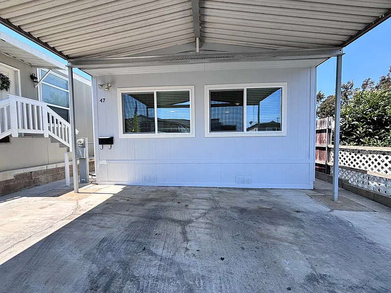 A covered carport offers convenient, protected parking, while additional outdoor storage adds practical value. With its low-maintenance exterior and welcoming appearance, this property is perfect for comfortable, easy living.