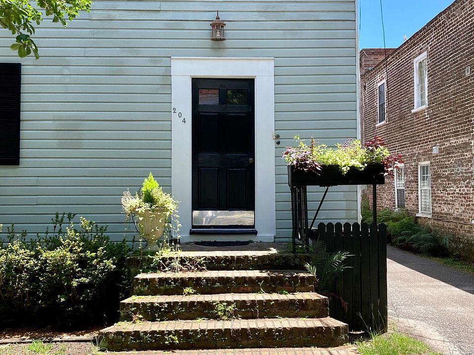 Front of the house at 204 Ashley Ave. Restoration work completed on exterior wood siding with insulation.