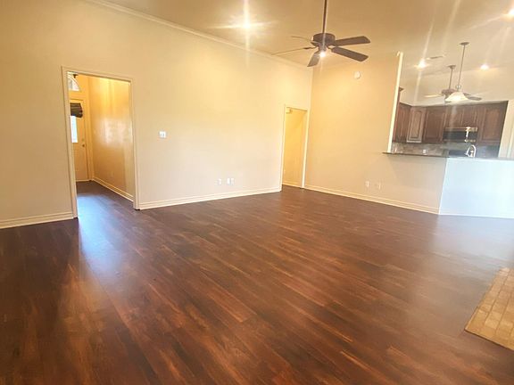 Additional angle of living room with view of entry and opens to the kitchen and breakfast area