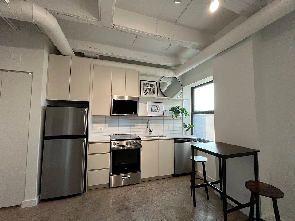 Typical apartment kitchen. Stainless steel appliances, dishwasher and microwave.