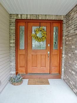 Beautiful entry door under the covered front porch, sure to impress your guests!