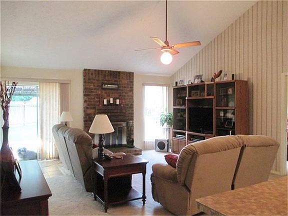 The living room is light and airy with high ceilings.