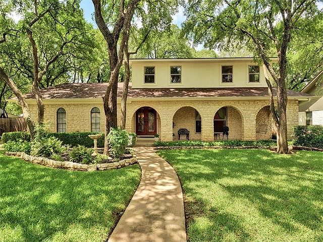 Beautifully trimmed oaks welcome you home.