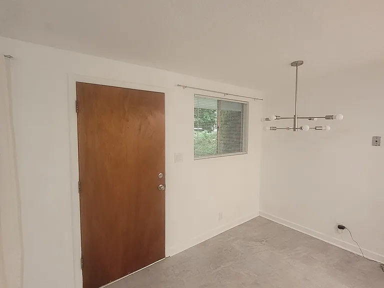 View of front entry door and dining space.