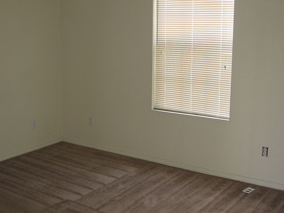 Bedroom has ceiling fan and walk-in closet