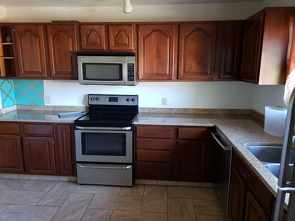 kitchen with quality appliances, tile floors; granite counter top, deep double bowl sink