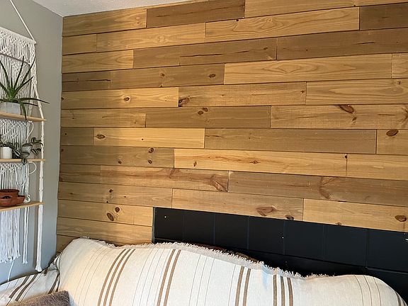 Some photos of the interior are old, this is a recent update on the fireplace wall. The mantle was removed and the wall paneled with wood.