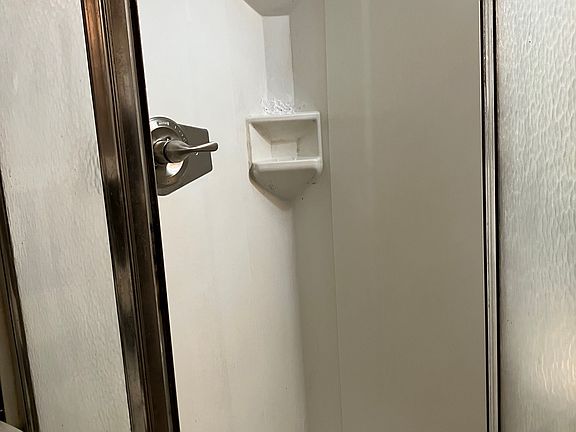 New shower stall, small sink, all new, medicine, chest, small toilet area.