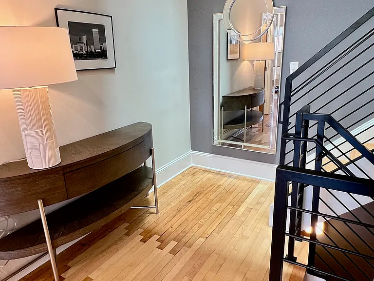 Spacious foyer with stunning mirror, perfect for last-minute check-up before an evening out.