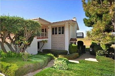 Side view of front of house showing path to undeveloped storage