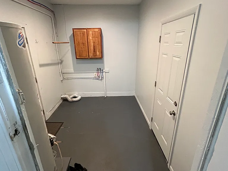 Mud room w/ washer/dryer hookups and doors to the backyard and garage.