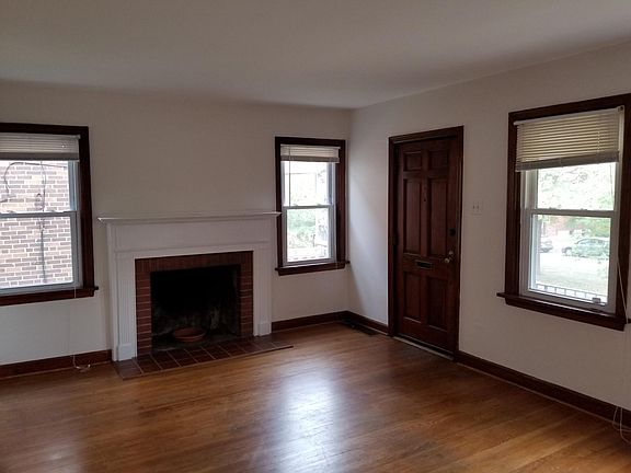 Living room brings lots of natural light with 4 windows. Plus decorative fireplace.