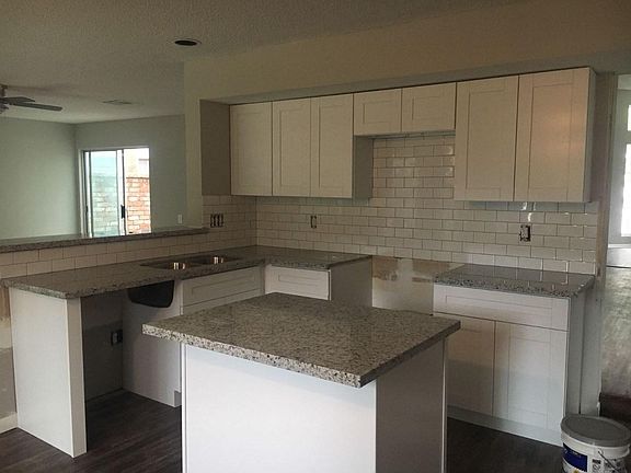 New cabinets, granite, backsplash in kitchen