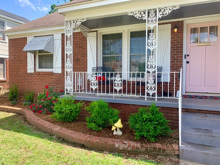 Covered front porch with sitting area.