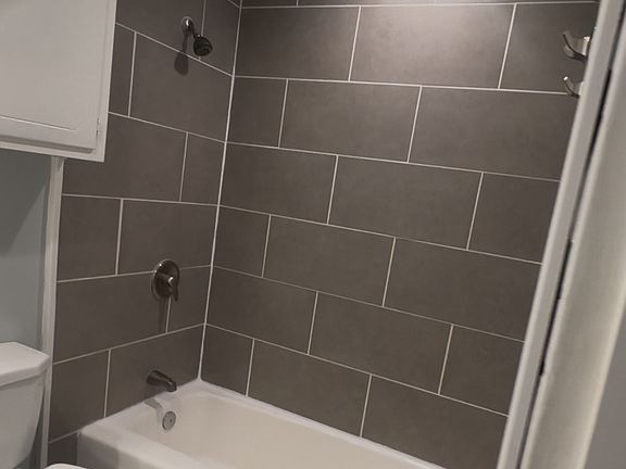 Ceramic tile, nickel hardware, curved shower rod and towel hooks already installed!