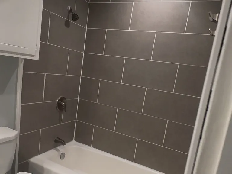 Ceramic tile, nickel hardware, curved shower rod and towel hooks already installed!
