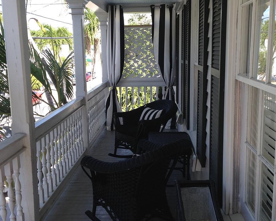 L shaped balcony faces street and property pool