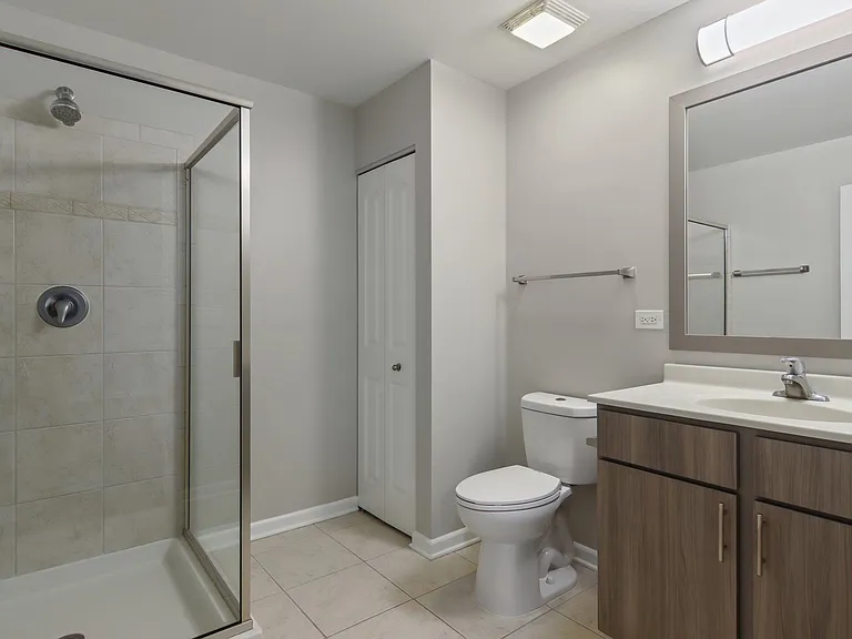 Bathroom with glass walk-in shower and modern vanity