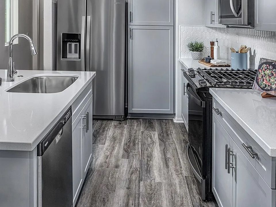 Kitchen featuring ample cabinetry, quartz countertops, and island seating