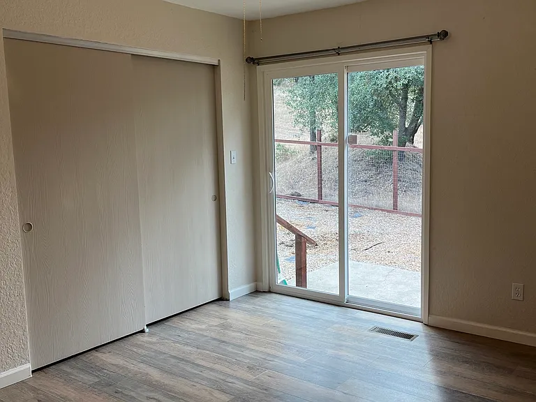 Master bedroom slider leads to backyard