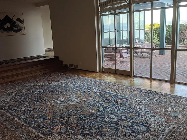 Palatial living room with doors to back patio. Rug and painting has been removed.