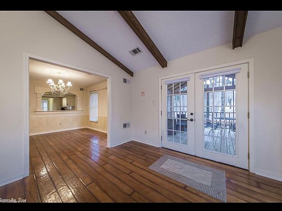 Living room with entry to dining room and french doors to screened in porch patio