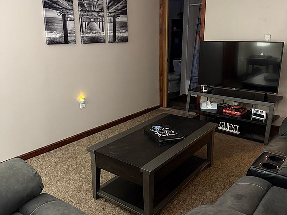 Living room with television and decor.