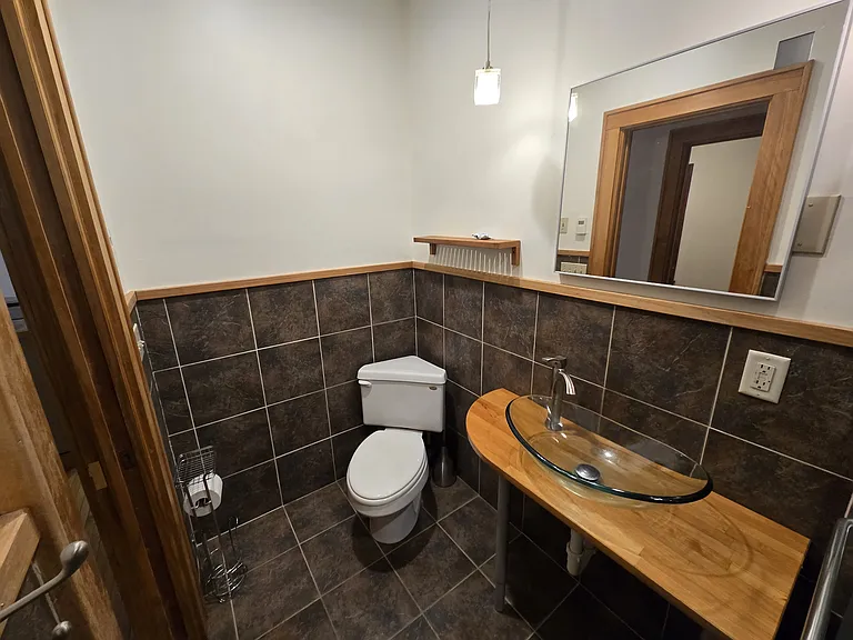 Bathroom, neat corner toilet and fully tiled with in-floor heat.