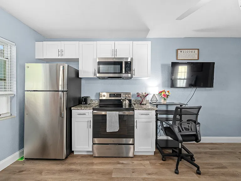 New Stainless Steel Appliances, Granite Countertops, and White Cabinets