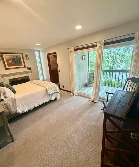 Second Story Primary Bedroom with Queen Plus Bed, Walk-In Closet, balcony and Gas Fireplace.