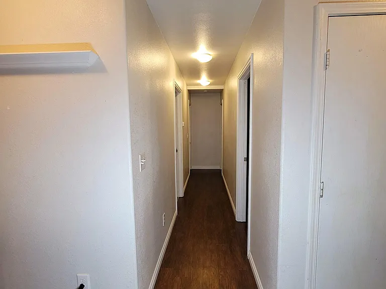 Hallway leading to 3 bedrooms and bathroom.