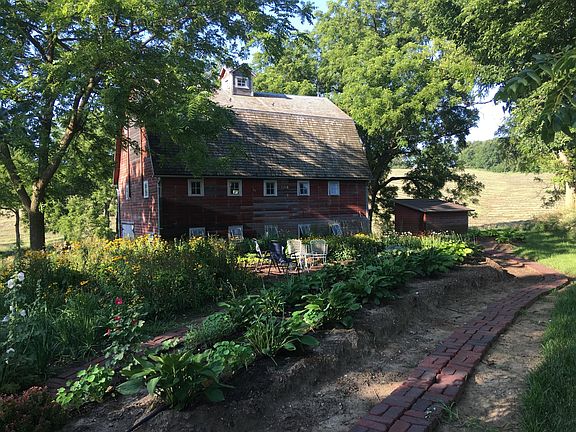 The barn was built in 1920 for hay above and milk cows below. We refurbished the barn and built this garden. The barn now has new windows, roof, doors, lighting and stairs to upstairs where barn dances have been happening. The first level has a new foun