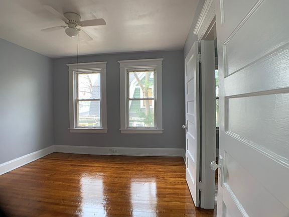 Bedroom #2 With two windows and newly finished hardwood floors.
