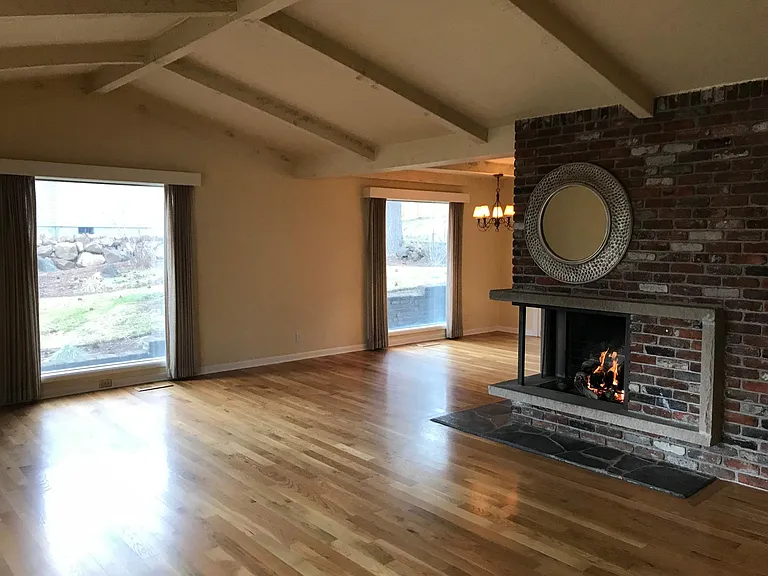 Living room with wrap around fireplace.