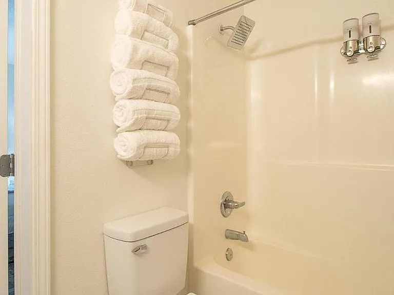 Private bathroom with rain shower across from private bedroom. Indulge in a luxurious and tranquil bathing experience.